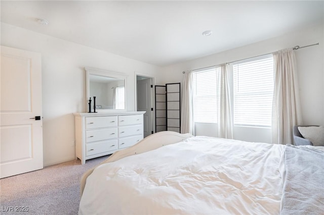 bedroom featuring light colored carpet