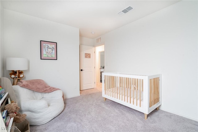 bedroom featuring visible vents, baseboards, and light carpet