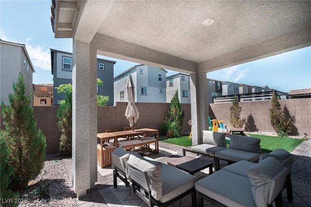 view of patio / terrace featuring a fenced backyard, an outdoor living space, and outdoor dining space