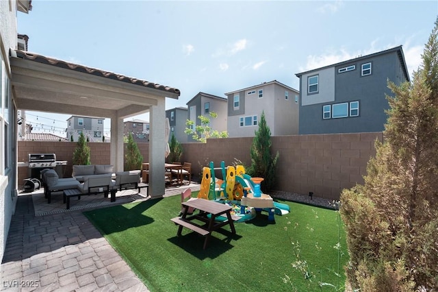 view of yard featuring a patio area, a fenced backyard, an outdoor hangout area, and a residential view