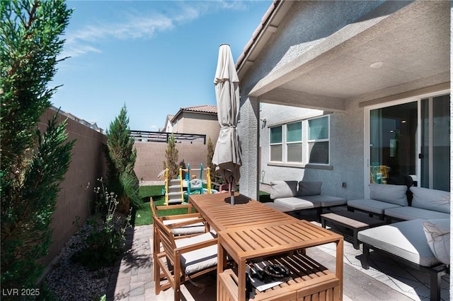 view of patio / terrace featuring an outdoor hangout area, outdoor dining area, and a fenced backyard