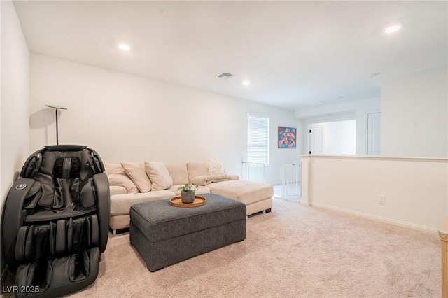 living room featuring baseboards, visible vents, recessed lighting, and light colored carpet