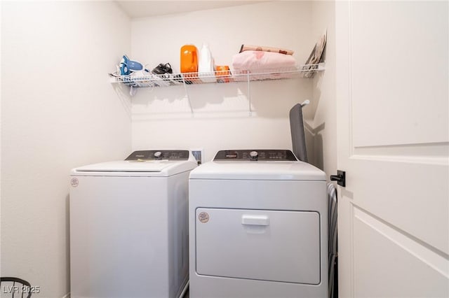 laundry room with washing machine and clothes dryer and laundry area