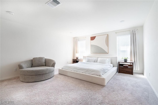 carpeted bedroom featuring baseboards, multiple windows, and visible vents