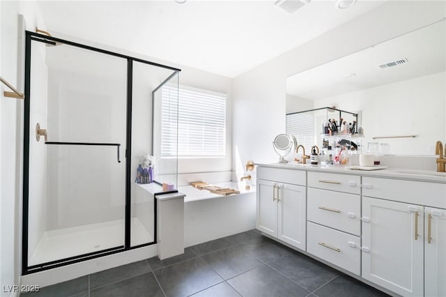 bathroom featuring a sink, double vanity, a stall shower, visible vents, and a garden tub