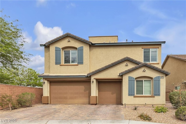 10412 Deer Heights St, Las Vegas, NV 89178 - view of front of property with decorative driveway, a tiled roof, an attached garage, fence, and stucco siding