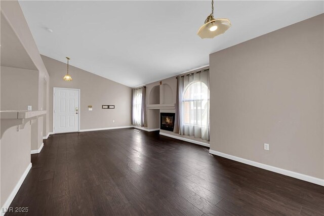 7950 W Flamingo Rd Unit 2019, Las Vegas, NV 89147 - unfurnished living room with vaulted ceiling, baseboards, and dark wood-style flooring