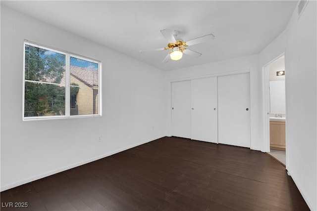 7950 W Flamingo Rd Unit 2019, Las Vegas, NV 89147 - unfurnished bedroom featuring baseboards, a ceiling fan, dark wood-style floors, and a closet