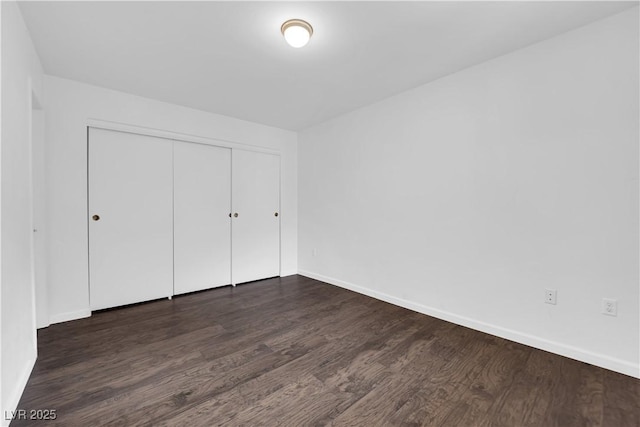 7950 W Flamingo Rd Unit 2019, Las Vegas, NV 89147 - unfurnished bedroom with baseboards, dark wood-style floors, and a closet