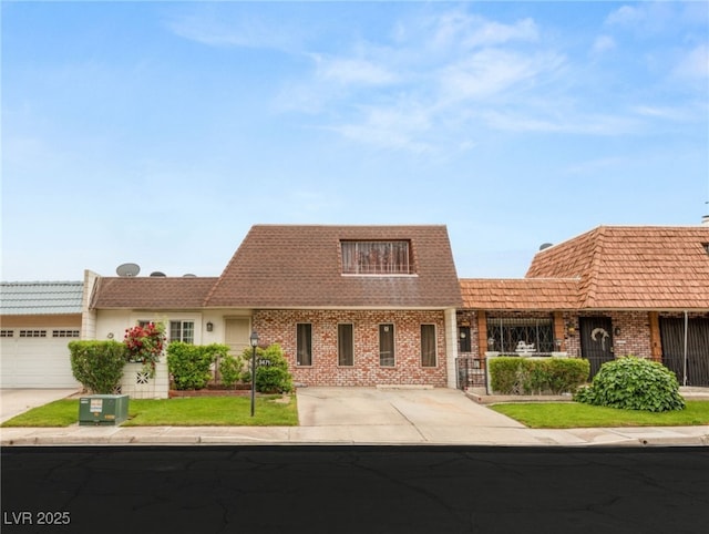 view of front of house featuring an attached garage, brick siding, and concrete driveway