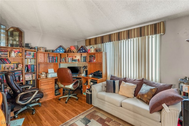 office area featuring wood finished floors and a textured ceiling