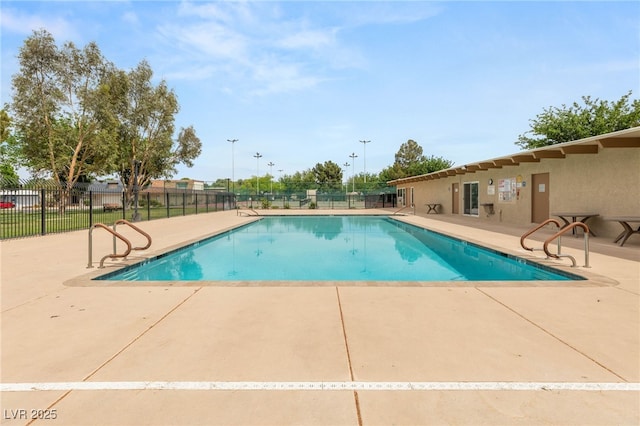 community pool featuring fence and a patio area