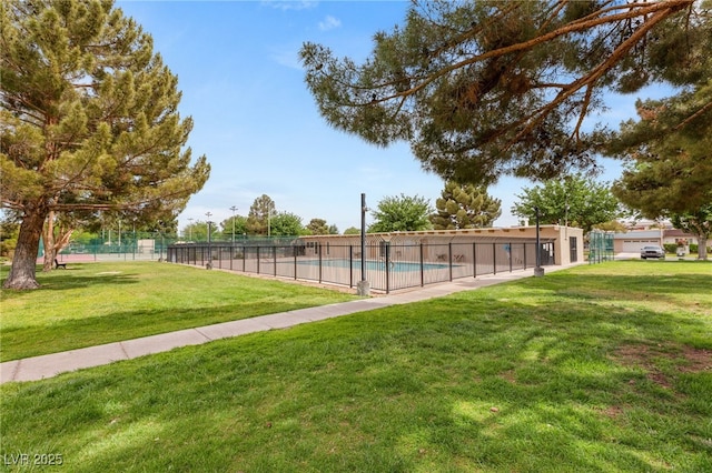 view of swimming pool featuring fence, a fenced in pool, and a yard