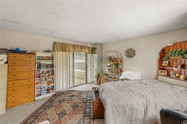 bedroom with carpet, access to outside, and a textured ceiling