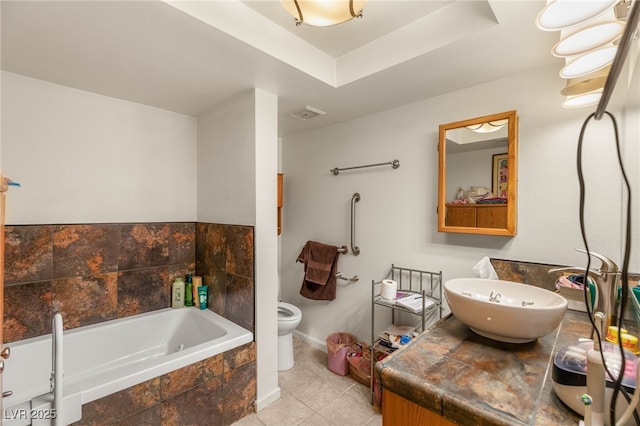 full bathroom with tile patterned floors, toilet, vanity, a bath, and baseboards
