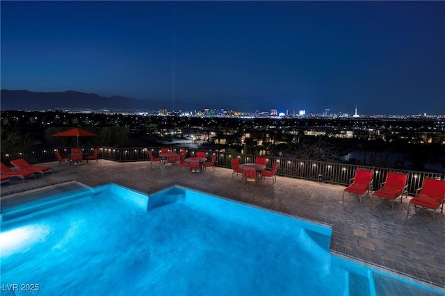1520 Macdonald Ranch Dr, Henderson, NV 89012 - pool at night featuring a fenced in pool and a view of city lights