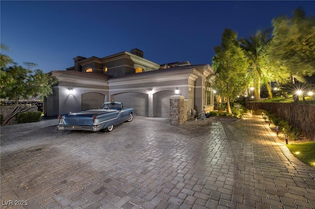 1520 Macdonald Ranch Dr, Henderson, NV 89012 - mediterranean / spanish home featuring an attached garage, a chimney, fence, and decorative driveway