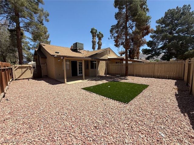 5653 White Cap St, Las Vegas, NV 89110 - back of house featuring stucco siding, a fenced backyard, a patio, and a gate