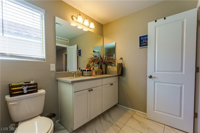 bathroom with visible vents, marble finish floor, vanity, and toilet