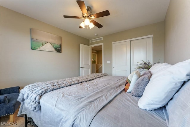 carpeted bedroom with a ceiling fan, visible vents, and a closet