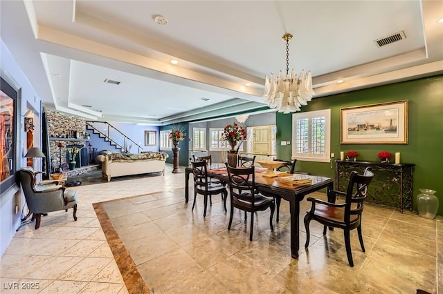 7165 Mira Monte Cir, Las Vegas, NV 89120 - dining space with visible vents, a tray ceiling, a notable chandelier, and stairway