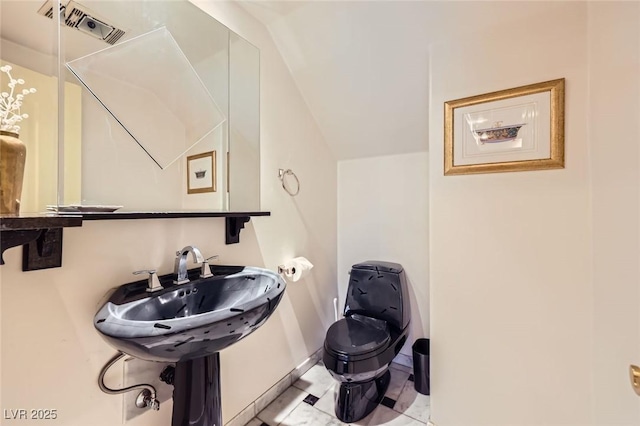 7165 Mira Monte Cir, Las Vegas, NV 89120 - half bath with toilet, vaulted ceiling, visible vents, and baseboards