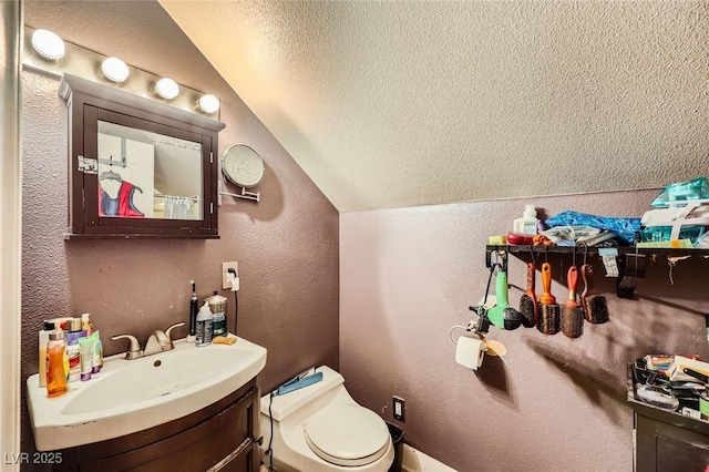 7165 Mira Monte Cir, Las Vegas, NV 89120 - bathroom with a textured ceiling, toilet, vaulted ceiling, a textured wall, and vanity