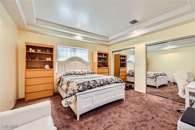 7165 Mira Monte Cir, Las Vegas, NV 89120 - carpeted bedroom with a tray ceiling, two closets, and visible vents
