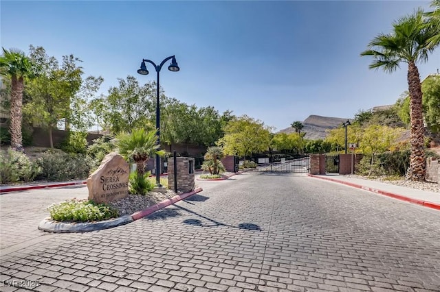 7165 Mira Monte Cir, Las Vegas, NV 89120 - view of street with a gate, sidewalks, a gated entry, curbs, and street lighting