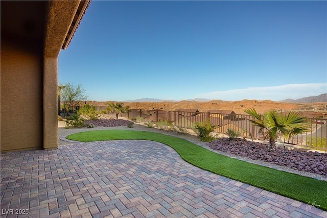 1130 Calico Rdg, Mesquite, NV 89034 - fenced backyard with a patio area and a mountain view