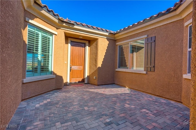 1130 Calico Rdg, Mesquite, NV 89034 - doorway to property with a patio area, stucco siding, and a tiled roof