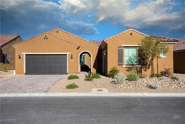 1130 Calico Rdg, Mesquite, NV 89034 - mediterranean / spanish home with a garage, stucco siding, driveway, and a tiled roof