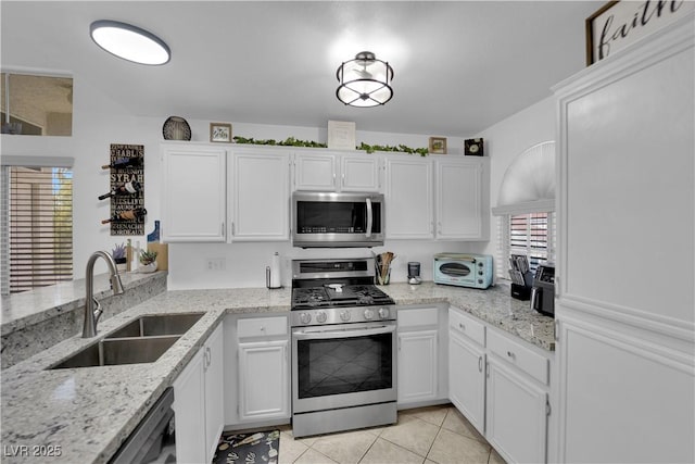 kitchen featuring white cabinetry, appliances with stainless steel finishes, and a sink