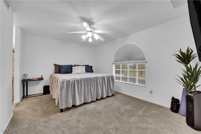 carpeted bedroom with ceiling fan and baseboards