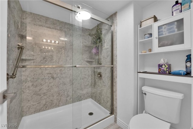 bathroom featuring a stall shower and toilet