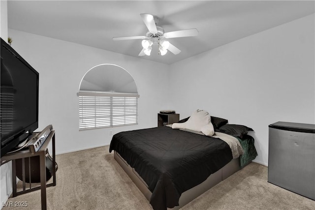 carpeted bedroom featuring baseboards and ceiling fan