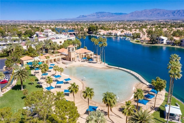 birds eye view of property with a water and mountain view