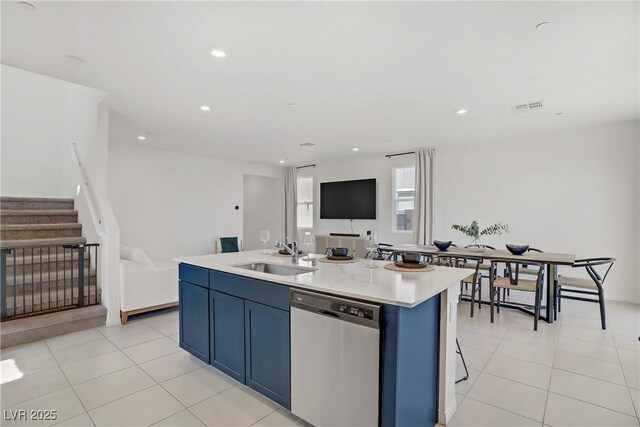 5692 Tinar St, Las Vegas, NV 89113 - kitchen with dishwasher, a sink, open floor plan, an island with sink, and blue cabinetry