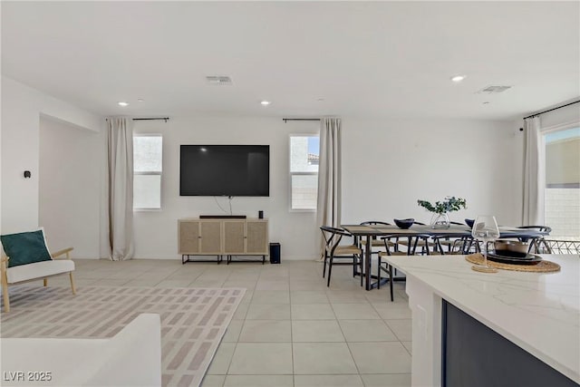 5692 Tinar St, Las Vegas, NV 89113 - living room with light tile patterned flooring, visible vents, and plenty of natural light