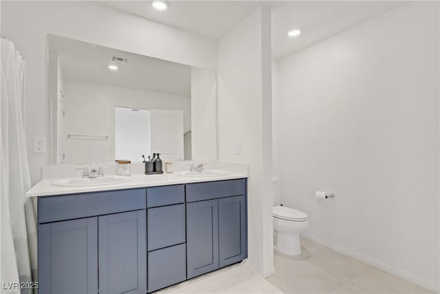 5692 Tinar St, Las Vegas, NV 89113 - full bathroom featuring toilet, a sink, visible vents, and double vanity