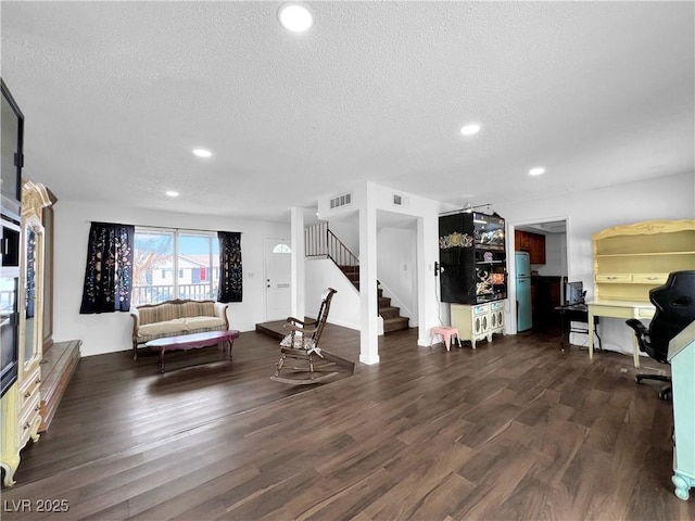 living room with recessed lighting, wood finished floors, visible vents, a textured ceiling, and stairs