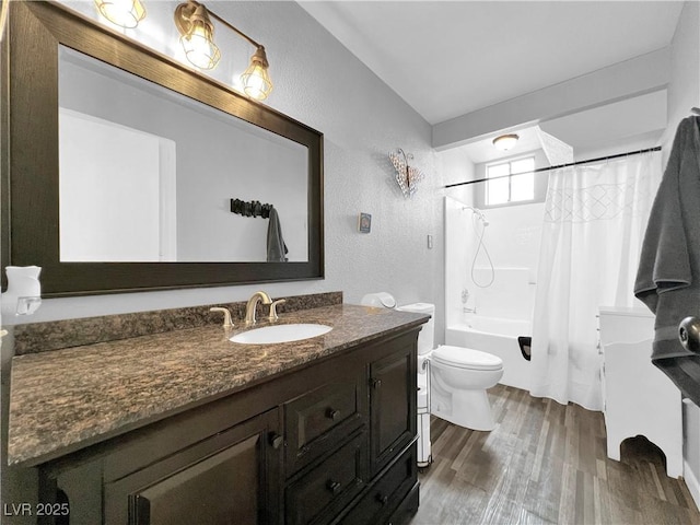 bathroom with shower / bathtub combination with curtain, a textured wall, wood finished floors, toilet, and vanity