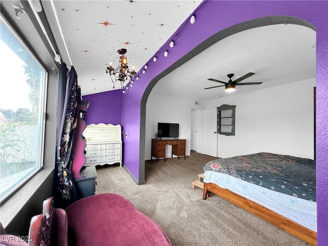 carpeted bedroom featuring arched walkways, ceiling fan, and multiple windows