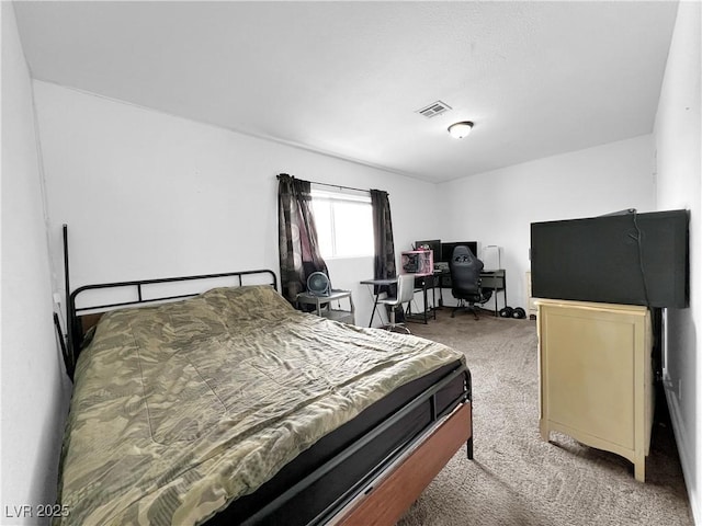 bedroom with visible vents and carpet