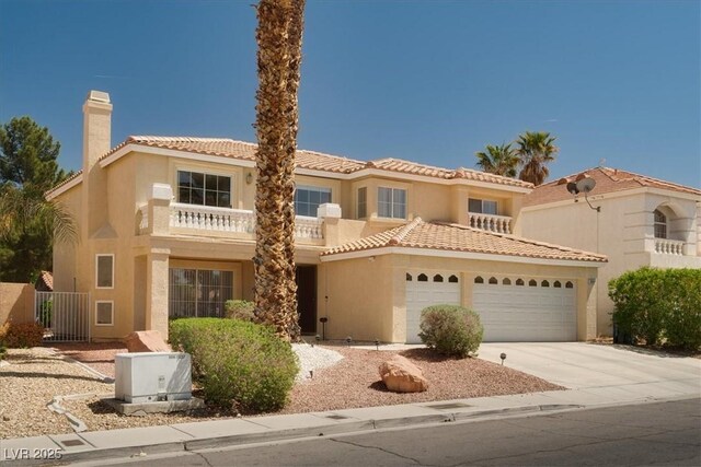 mediterranean / spanish house featuring a garage, a tiled roof, stucco siding, a chimney, and driveway