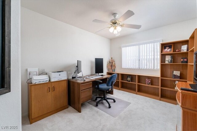 home office featuring light colored carpet and a ceiling fan