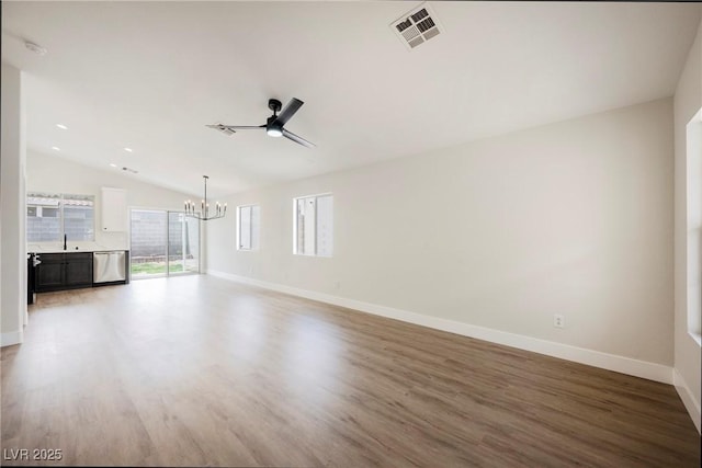 unfurnished living room featuring visible vents, baseboards, light wood-style floors, and vaulted ceiling