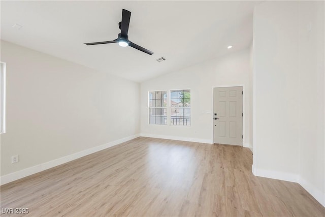 unfurnished living room with a ceiling fan, visible vents, vaulted ceiling, baseboards, and light wood-style flooring