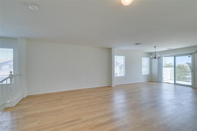 11668 Tierney Creek Dr, Las Vegas, NV 89183 - empty room with a chandelier, light wood-style flooring, and baseboards