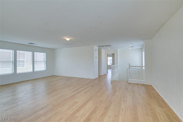 11668 Tierney Creek Dr, Las Vegas, NV 89183 - unfurnished living room with healthy amount of natural light and light wood-style floors